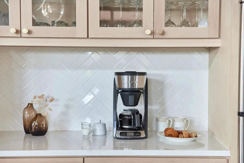 Heat N Brew 10 Cup Programmable Coffee Maker with Stainless Steel Finish on kitchen counter, ideal for home cafe.