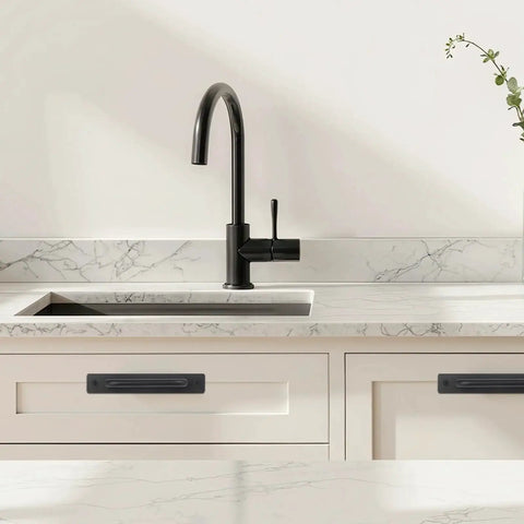 4 Pack Black Zinc Alloy Barn Door Handles Set installed on white kitchen cabinets below black faucet.