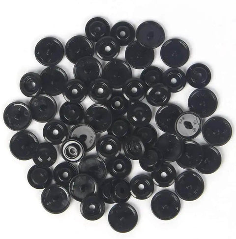 Black plastic pieces from Snap Fasteners Kit With Pliers, 420 Complete Sets In 14 Colors, No Sew Plastic Snaps for Crafts and Clothing.