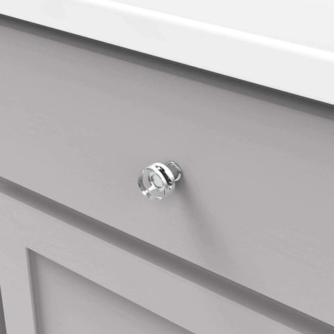 Solid Core Kitchen Cabinet Knobs In Crysacrylic With Chrome Finish 1 Inch Luxury Cabinet And Dresser Knobs Handles For Doors And Drawers Midway Collection By Hickory Hardware installed on a gray cabinet drawer.