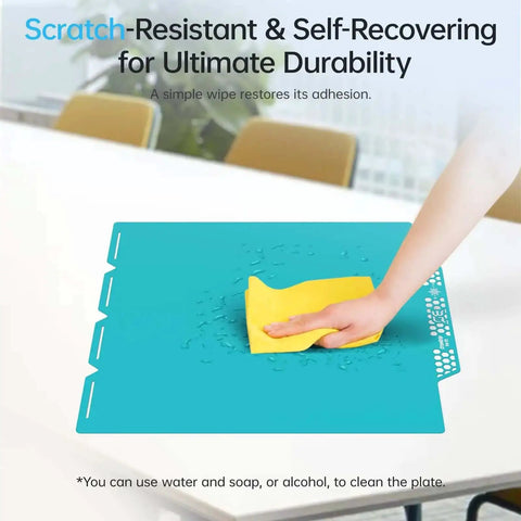 Cleaning the CryoGrip Pro Glacier Build Plate for Snapmaker U1 3D Printer with a yellow cloth, shows scratch-resistant surface.