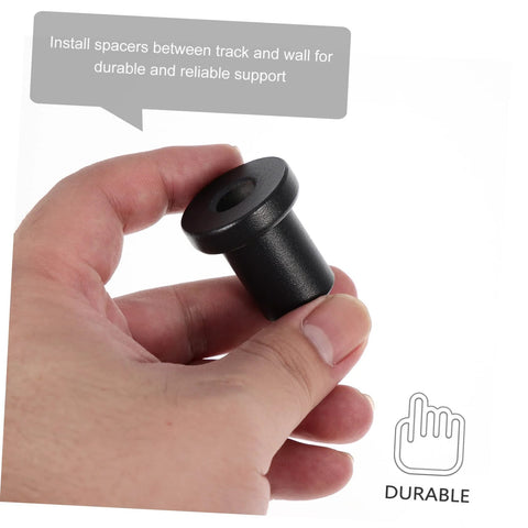 Hand holding iron spacer from 4 Pack Sliding Barn Door Track Spacers Set For Wall And Rail Connectors Easy Install Hardware.