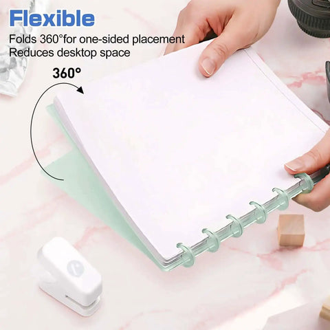 Mini Mushroom Hole Punch 1 Hole Puncher Handheld Paper Punch for Booklets and Crafts shown on pink marble desk with ringed paper