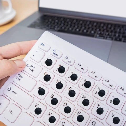 Black Round Adhesive Bumper Pads 300 Pcs Combo Pack in 3 sizes used on a keyboard for sound dampening and preventing slippage