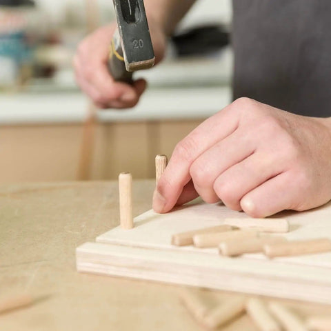 Inserting dowel pins into wood for woodworking; Dowel Pins One Quarter Inch By One And A Half Inch Fluted Hardwood Pegs For Woodworking And Model Building 100 Pack Pro Grade DIY Ready Heavy Duty For Strong Joints And Superior Glue Adhesion.