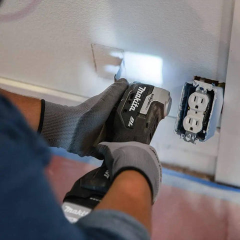 18V LXT Sub-Compact Brushless Cordless Multi-Tool with Variable Speed Control in use cutting wall near electrical outlet.