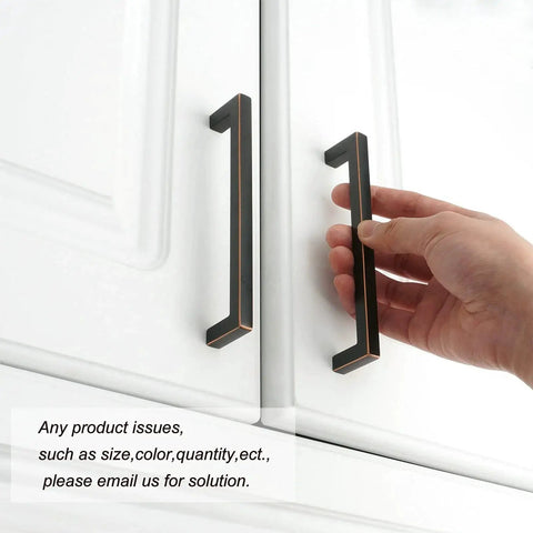 Hand holding Oil Rubbed Bronze Solid Square Kitchen Cabinet Handle 5 Inch on white cabinet door, easy install hardware