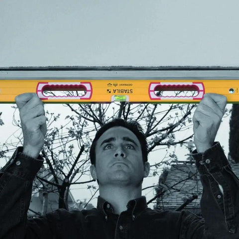 Man using Stabila 37424 24 Inch Builders Level With High Strength Box Frame For Framing Tile And Trim Work Lifetime Accuracy