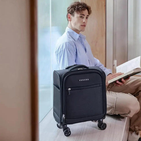 Underseat Carry On Luggage With Wheels Softside Lightweight Travel Bag for men, black, shown next to seated man with book