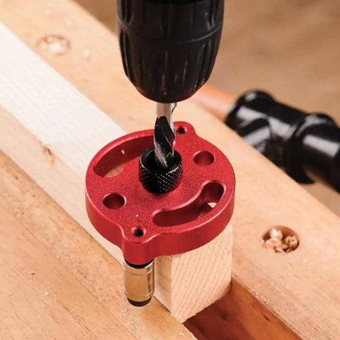 Centering Doweling Jig And Dowel Drill Guide for Perfect Straight Holes in Wood Panels in use, red aluminum, 70x58 mm size.
