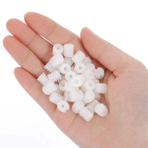 Hand holding 100 Pack Nylon Cabinet Hinge Dowels 0.34 By 0.39 Inches Plastic Furniture Dowel Pins For A Quick Fix And Easy Install Durable Nylon Construction For Long Lasting Cabinet And Furniture Hinges