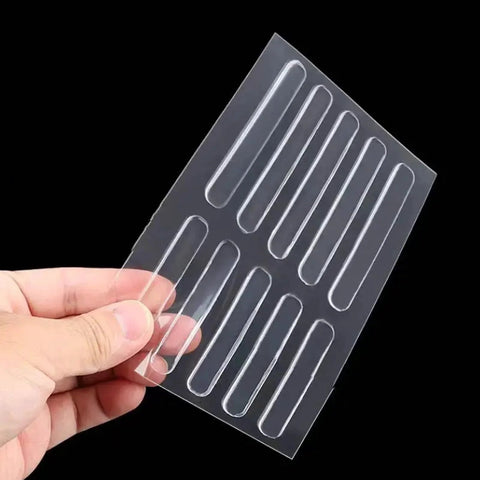 Hand holding sheet of self-adhesive rubber bumper strips for door slam prevention and furniture cushioning