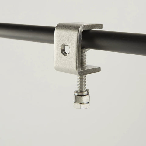 C-clamp side view, stainless steel 1-inch jaw gripping a black bar; woodworking clamp