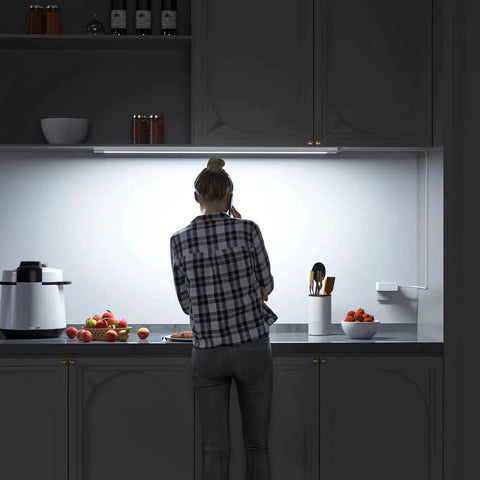 Person using Plug In 24 Inch Under Cabinet Light Bar With Wave Sensor for kitchen task lighting, touchless dimming.