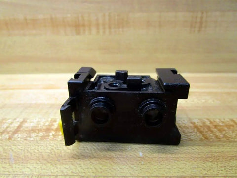 Manifold P-027050-00001 replacement for Bosch Rexroth systems, black single block with valve-mounting ports on wood surface