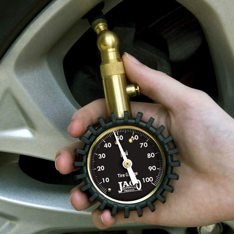 JACO Elite tire pressure gauge with brass nozzle and black 0–100 psi dial, handheld.