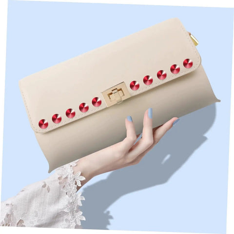 Hand holding beige purse with red plastic rivets from Plastic Decorative Rivet Stud Kit For Clothing And Bags DIY Rivets Buckle Set.