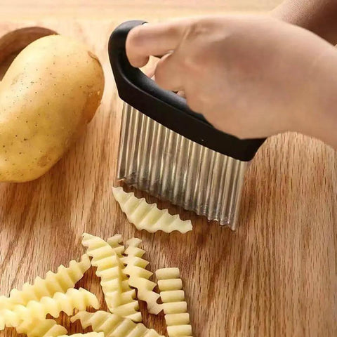 Hand slicing potato into crinkle cuts with All Purpose Waffle Fry Cutter And Crinkle Cutter For Potatoes Cucumbers Carrots Ergonomic Handheld Kitchen Tool With Handle Stainless Steel Rust Resistant Blade Wavy Chopper For Fries Fruits Vegetables And Salads Silver And Black.