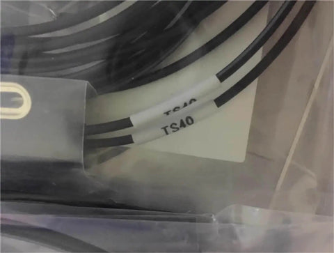 Close-up of LL3-TS40 sensor cable from LL3 fiber optic sensor series for industrial automation and photoelectric sensing.