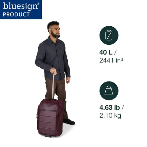 Person holding Ozone 2-Wheel Carry-On Luggage With Oversized Wheels And Telescoping Handle From Osprey, showing 40L capacity