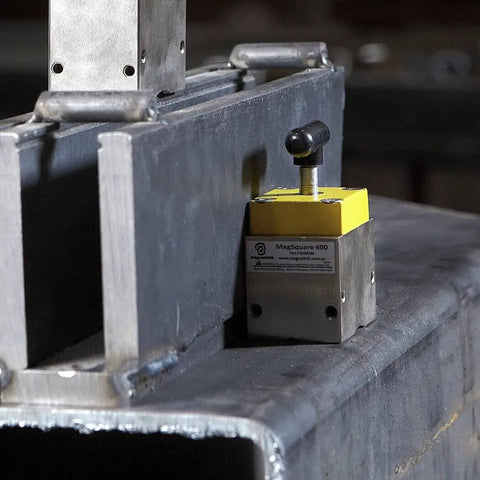 Magnetic Welding Square Base Clamp Holder With On Off Capabilities And Beefy 400 Pound Holding Force For Welding Kits And Fixturing in use on a metal surface.