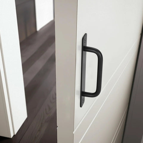 Black Barn Door Handles 4 Pack With 5 Inch Hole Center Aluminum Sliding Door Pulls on a white door close-up view.