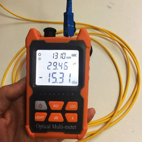 Mini optical fiber power meter, orange handheld tester with yellow fiber and blue FC/SC/ST universal interface.