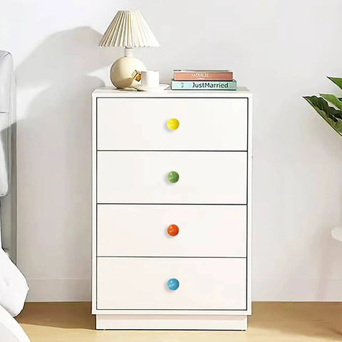 White dresser with multicolored knobs in room setting, showing Six Pack Ceramic Cabinet Knobs One And A Quarter Inch White.