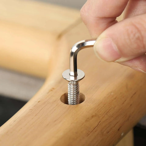 1/4-20 Stainless Socket Head Cap Screws, 1 Inch Long, Full Thread Countersunk Bolts, 304 Stainless Steel With Black Zinc Finish, being installed with hex spanner in wooden surface.