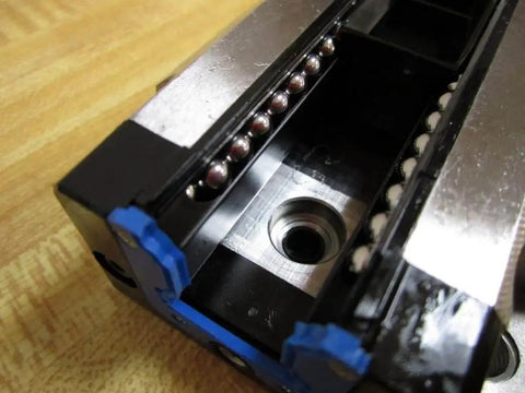 Close-up of R165129310 Ball Carriage Rexroth Kugelwagen showing internal ball bearings for linear guide rails precision motion