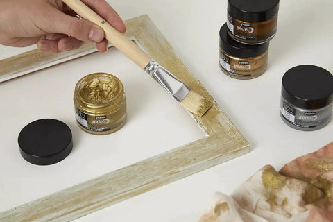 Applying Gilding Wax King Gold Metallic Paste For Furniture, Plaster, Glass, Metal And Paper with brush on wood frame