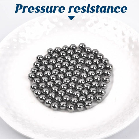 G25 precision bearing balls, chrome steel, 3 mm, mirror-polished, clustered on a white plate