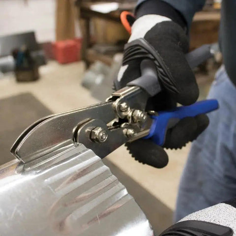 Five Blade Ductwork Crimper With Compound-Leverage in use on 24 gauge steel pipe, creating precise indentations.