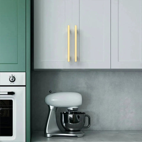 Modern kitchen with 10 Pack 5 Inch Brushed Gold Cabinet Handles For Kitchen Cabinets And Drawers installed on white cupboard doors.