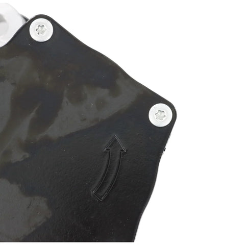 DYRDINSHOW brake vacuum pump housing, black metal plate with two silver screws and an embossed arrow (close-up)