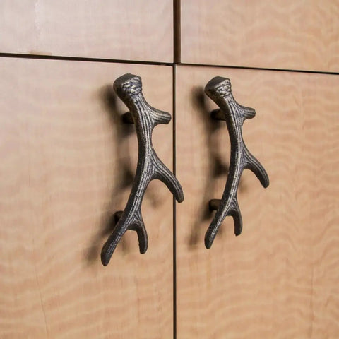 Antique Bronze Finish Cast Iron Deer Antler Drawer Pulls Set Of Six For Cabinets against wooden surface