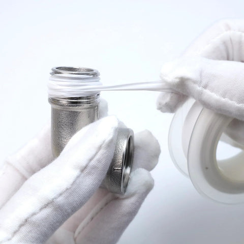 Stainless steel 90-degree elbow, 1/2 in NPT, female x male, 304 stainless, held by gloved hands