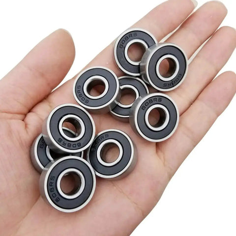 Hand holding 24 Pack Double Rubber Sealed 608-2RS Ball Bearings 8x22x7mm For DIY Furniture Wheels Skateboards Inline Skates