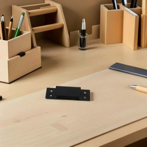 Hidden Door Hinge 5 Inch Black Concealed Pivot on desk, ideal for cabinets and secret doors, shown with alignment features
