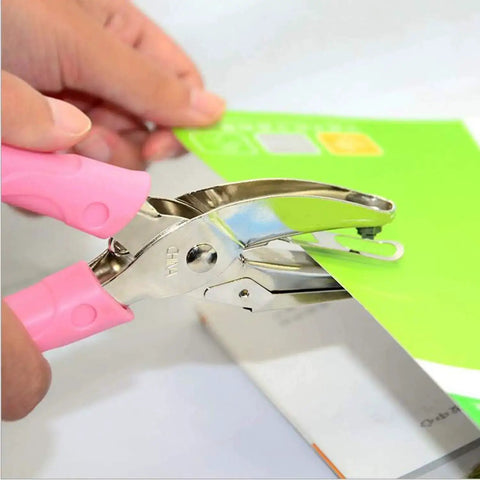 Close-up of Two Pack 1/16 And 1/8 Inch Circle Hole Punches For DIY Crafts And Scrapbooking handheld tool in use on paper.