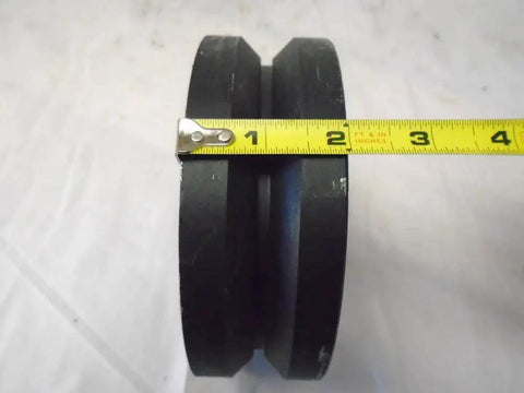 Close-up of 4 Pack Swivel Caster Wheel Set 6x2 Inch With Seven Eighths Inch V Groove Iron Steel Wheels showing side view with measuring tape.