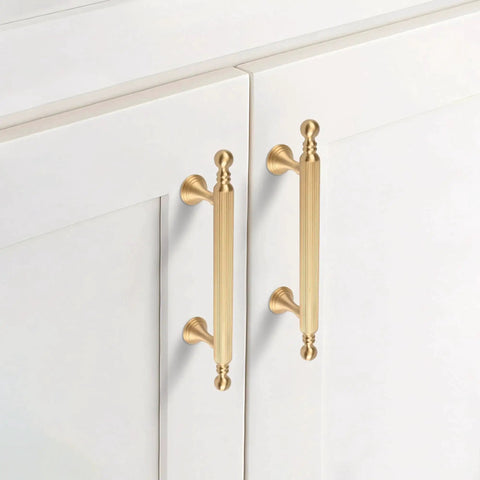 Two Pack Solid Brass Cabinet Handles In Gold Finish, 6.22 Inch Length, installed on white cabinet doors