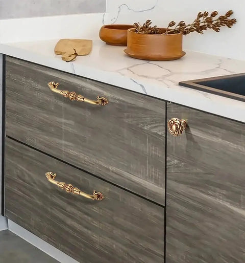 Two Pack 5 Inch Brass Cabinet Pulls Antique Floral Pattern Cupboard Handles installed on kitchen drawers with matte gold finish
