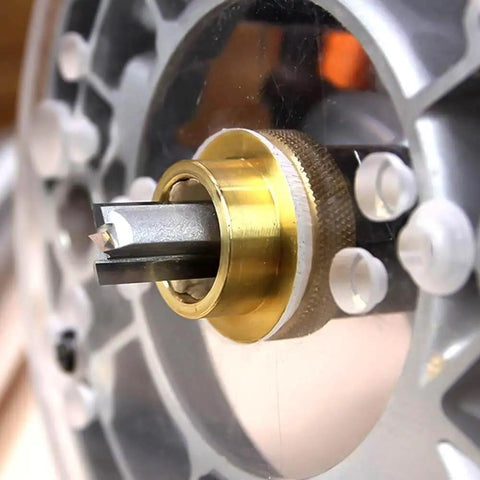 Close-up of 9-piece Brass Router Bushing Set installed on router base with 1-3/16 inch plate opening for precise edge routing.