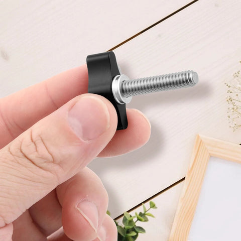 Hand holding black Four Pack 1/4-20 Thumb Screw With Wing Knob, Aluminum Knob and Stainless Steel Thread, 1-1/4 Inch Long for DIY Projects.