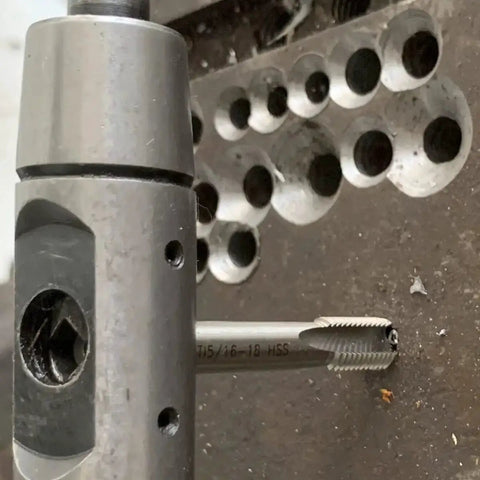 Close-up of M5 X 0.8 Helical STI Thread Repair Kit in use, showing tap tool and inserts for repairing damaged holes in metal