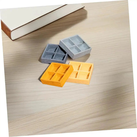 Four Grid Dollhouse Storage Box Resin Organizer For Candy, Nuts, And Sweet Tiny Treats in assorted colors on a table
