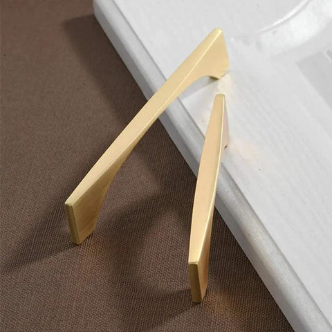 4 Pack Brushed Gold Cabinet Drawer Pulls In Zinc Alloy With Brushed Brass Finish on brown surface next to white card