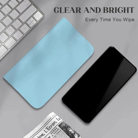 Blue microfiber cloth from 30 Pack Microfiber Cloths For Glasses And Electronics With 2 Lens Sprays next to smartphone and keyboard.