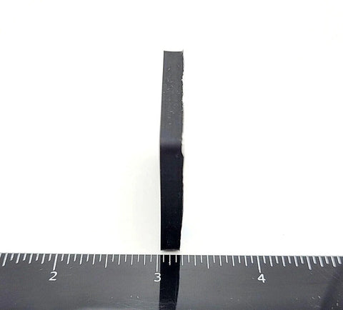 Side view of a 1.5-inch square silicone rubber stick-on foot bumper showing the thickness with a ruler for scale. Non-slip adhesive pad.